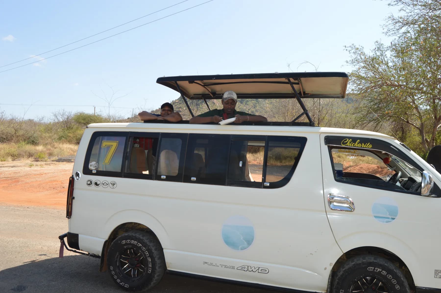 A white Funke Adventures safari van with its roof raised